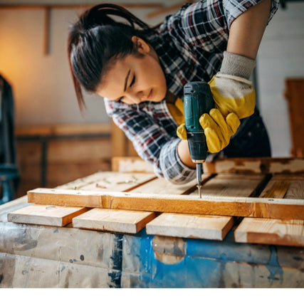 Do It Yourself RentalsWoman using a power drill on wood fence frame inside of a garage