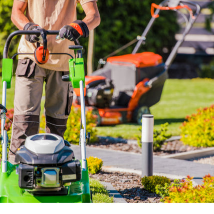 Landscaping RentalsLandscaper pushing a lawn mower with a riding mower behind them