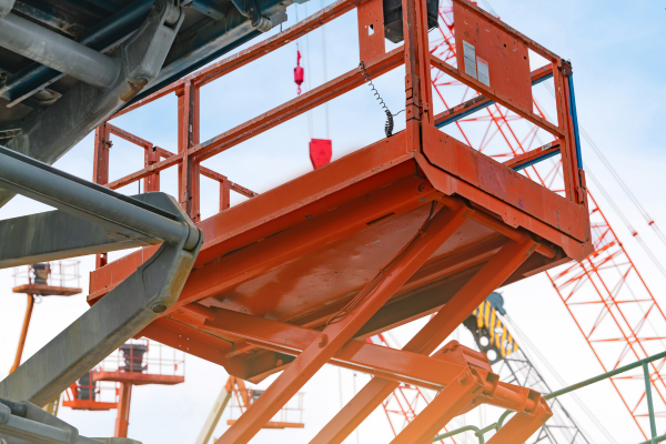 Orange boom lift on a clear day